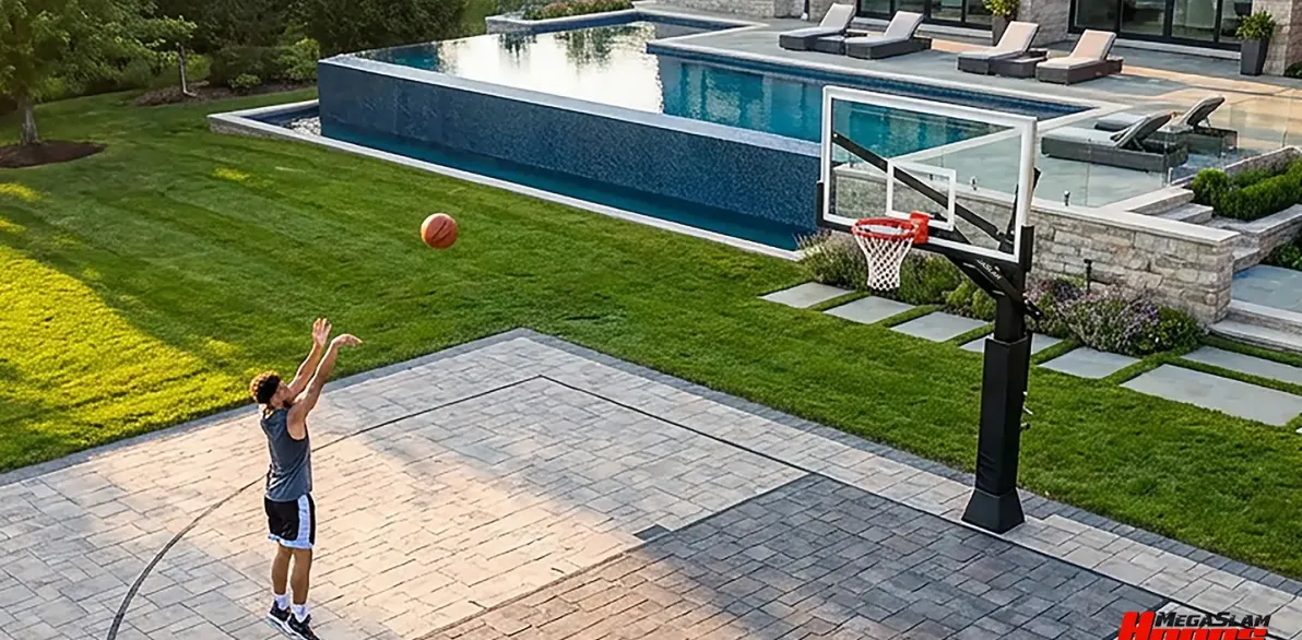 Player shooting on a Mega Slam in-ground hoop at a luxury backyard home court
