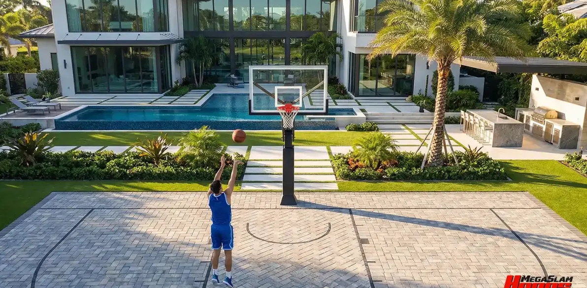 Player shooting on a Mega Slam Adjustable Series in-ground hoop at a modern home court