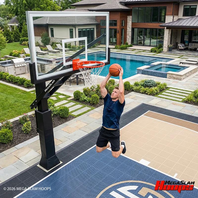 Player dunking on a Mega Slam in-ground hoop over a tiled backyard court