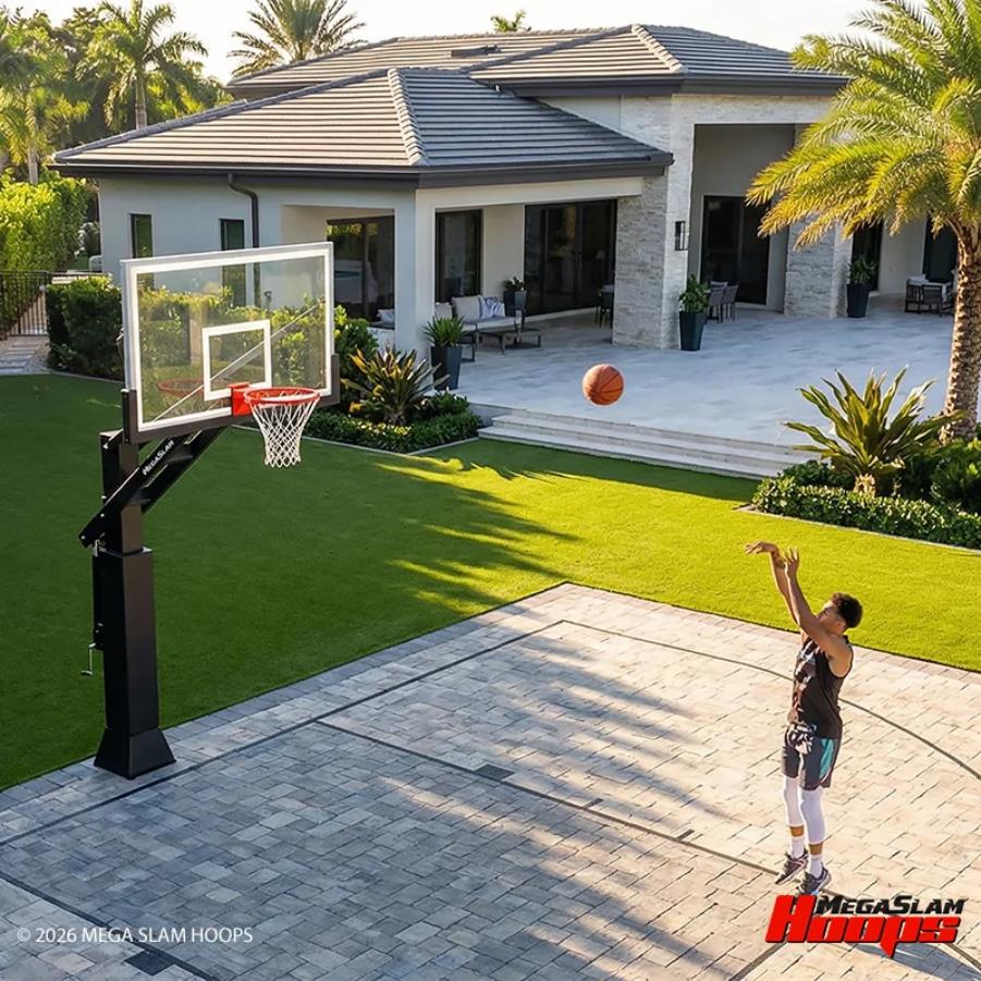 Player shooting on a Mega Slam in-ground hoop on a paver backyard court